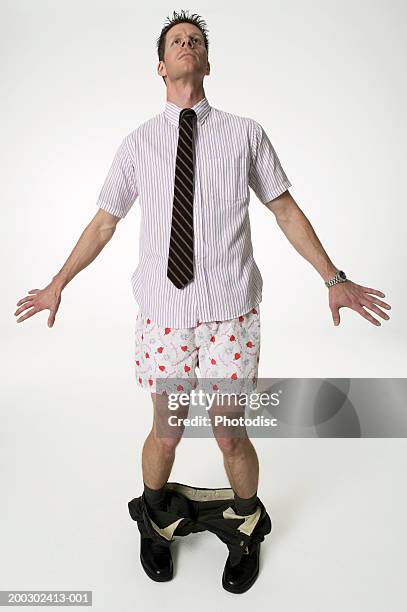 young man standing in studio with trousers around ankles - pants down bildbanksfoton och bilder