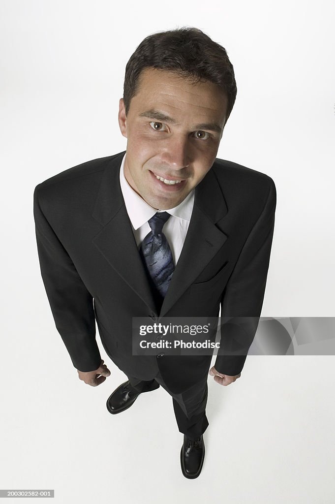 Businessman standing in studio, portrait, elevated view