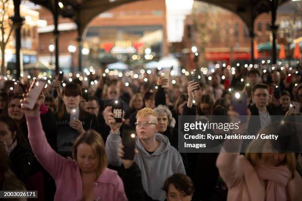 Phone torches are lit to mark a minutes silence during a vigil to mark the 1 year anniversary of Brianna Ghey's death in the Old Market Hall on...