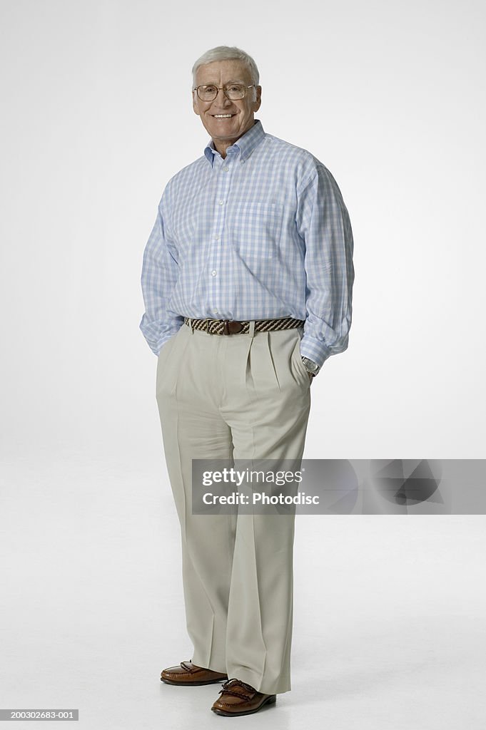 Senior man wearing glasses, posing in studio, portrait