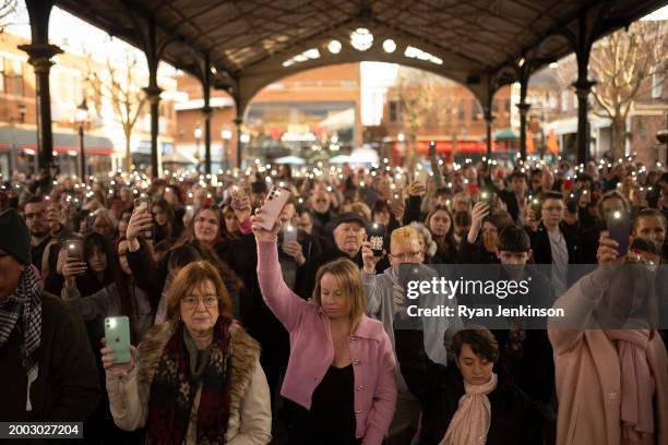 Phone torches are lit to mark a minutes silence during a vigil to mark the 1 year anniversary of Brianna Ghey's death in the Old Market Hall on...