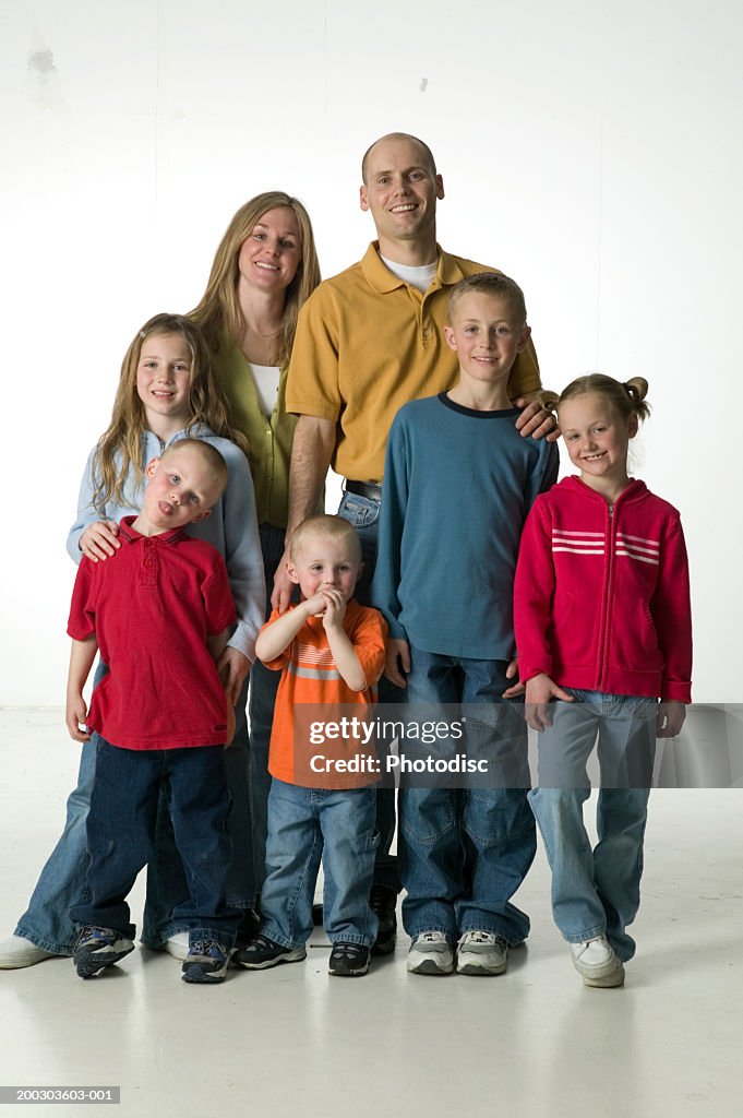 Two parents with five children, posing in studio, portrait