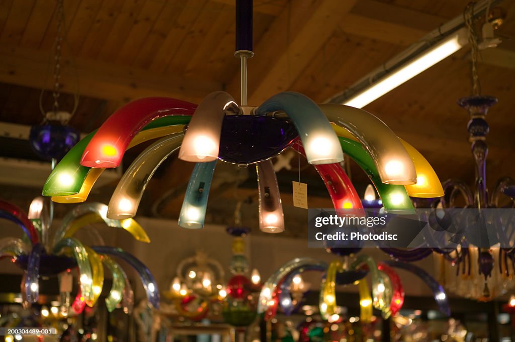 Multi-coloured light hanging from ceiling in light shop, close-up