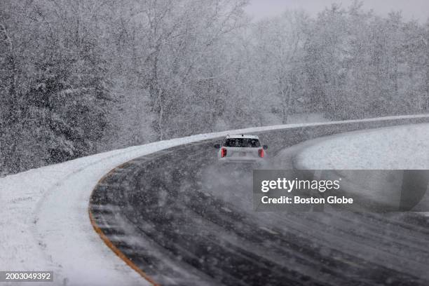 North Attleboro, MA A car maneuvers through a snowy I-95 South.