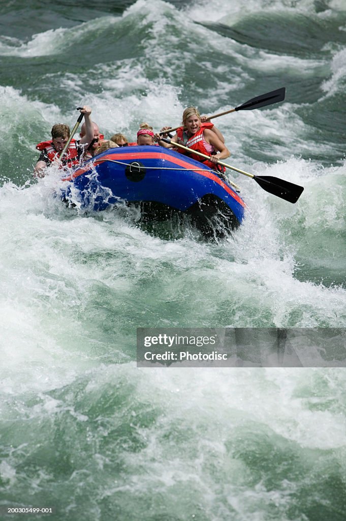 Group of people white-water rafting on river, elevated view