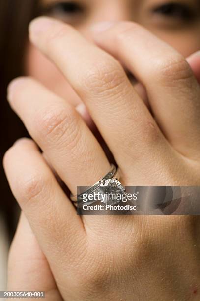 young woman, close up of ring on finger - skin diamond stock pictures, royalty-free photos & images