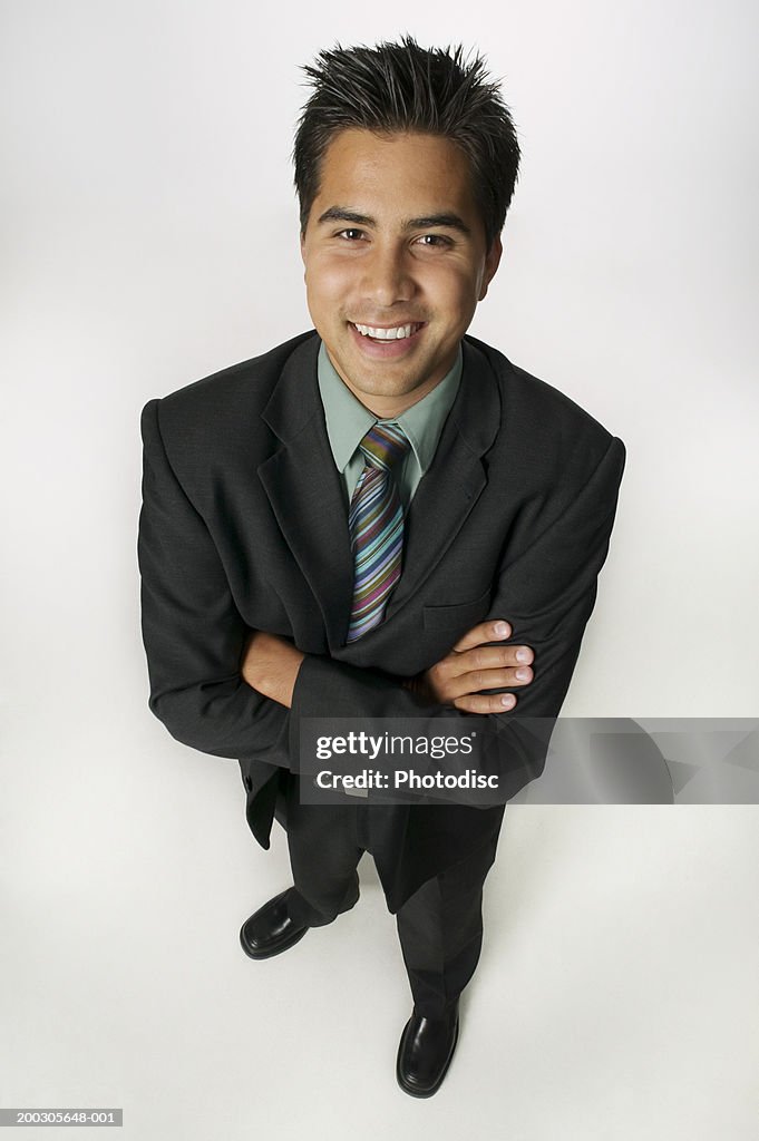 Young businessman standing in studio, portrait, elevated view