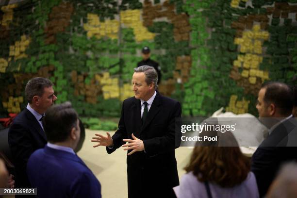 Foreign Secretary David Cameron speaks to Bulgarian officials as he attends a demonstration of Bulgarian customs and border police on fighting...