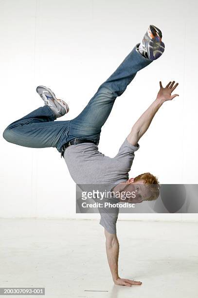 young man break dancing, posing in studio, portrait - grey jeans fotografías e imágenes de stock