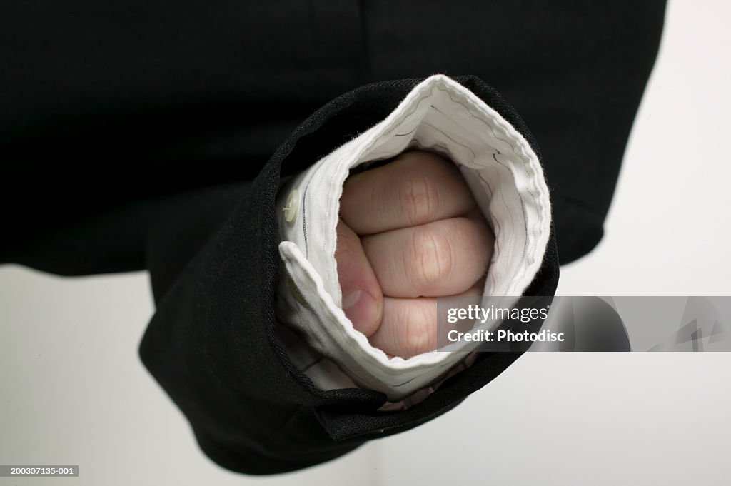 Persons knuckles inside shirt sleeve, close-up