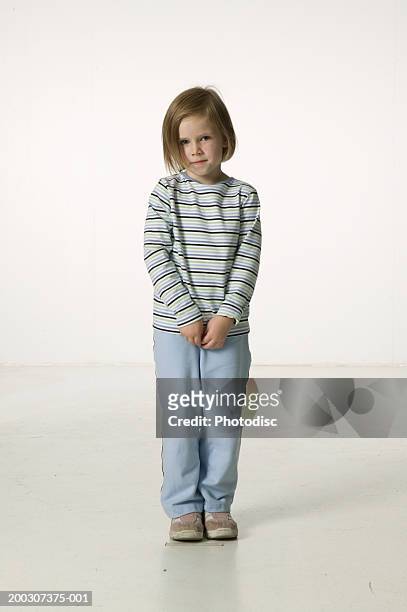 girl (6-7) standing in studio, portrait - shy bildbanksfoton och bilder