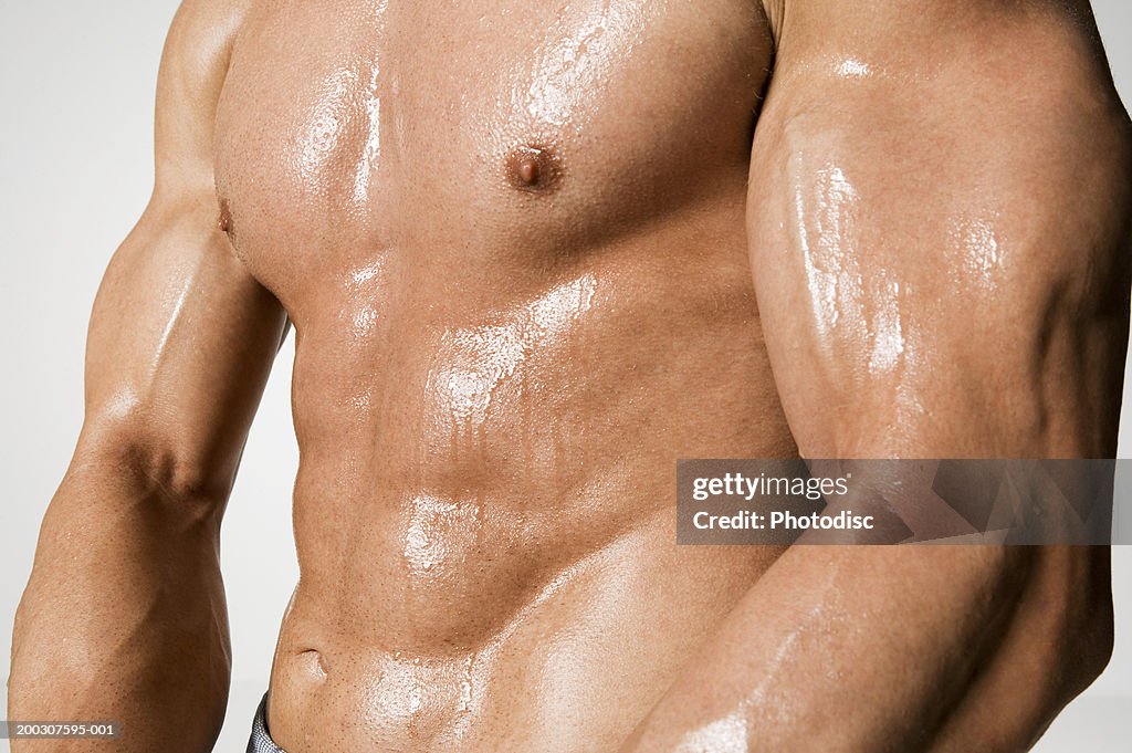 Man presenting muscles, mid section