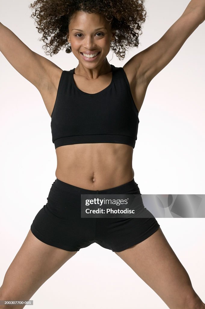 Woman Wearing Aerobics Outfit In Midair Leap High-Res Stock Photo - Getty  Images