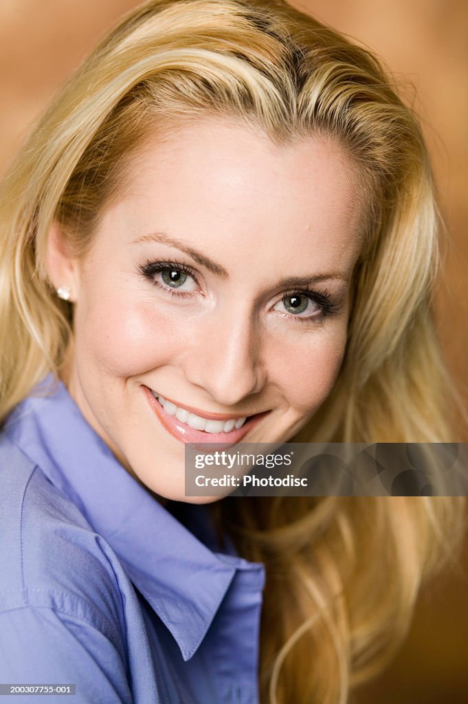 Woman with blond hair standing indoors, posing, close-up, portrait