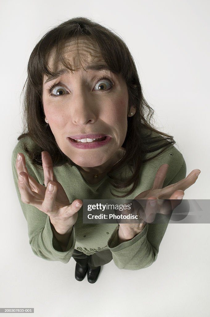Exasperated woman in studio, close-up, elevated view
