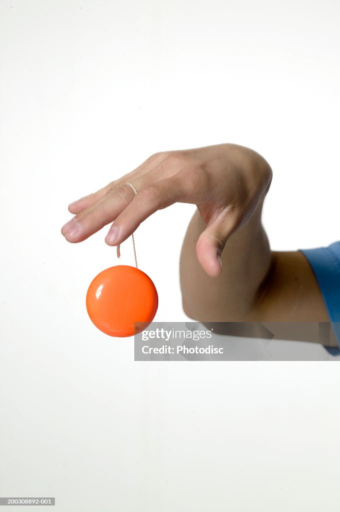 Woman playing with yo-yo, close-up of hand, close-up