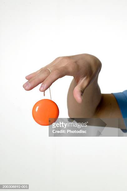 woman playing with yo-yo, close-up of hand, close-up - yo yo stock pictures, royalty-free photos & images