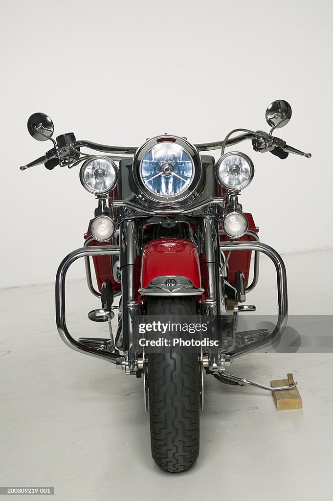 Red motorcycle parked in studio