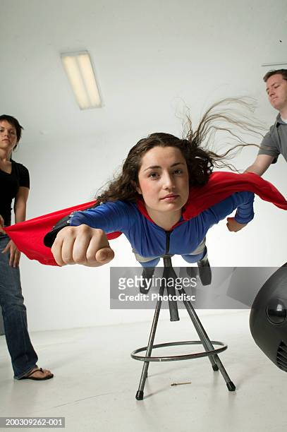 young woman dressed as superwoman, in studio - superwoman stockfoto's en -beelden