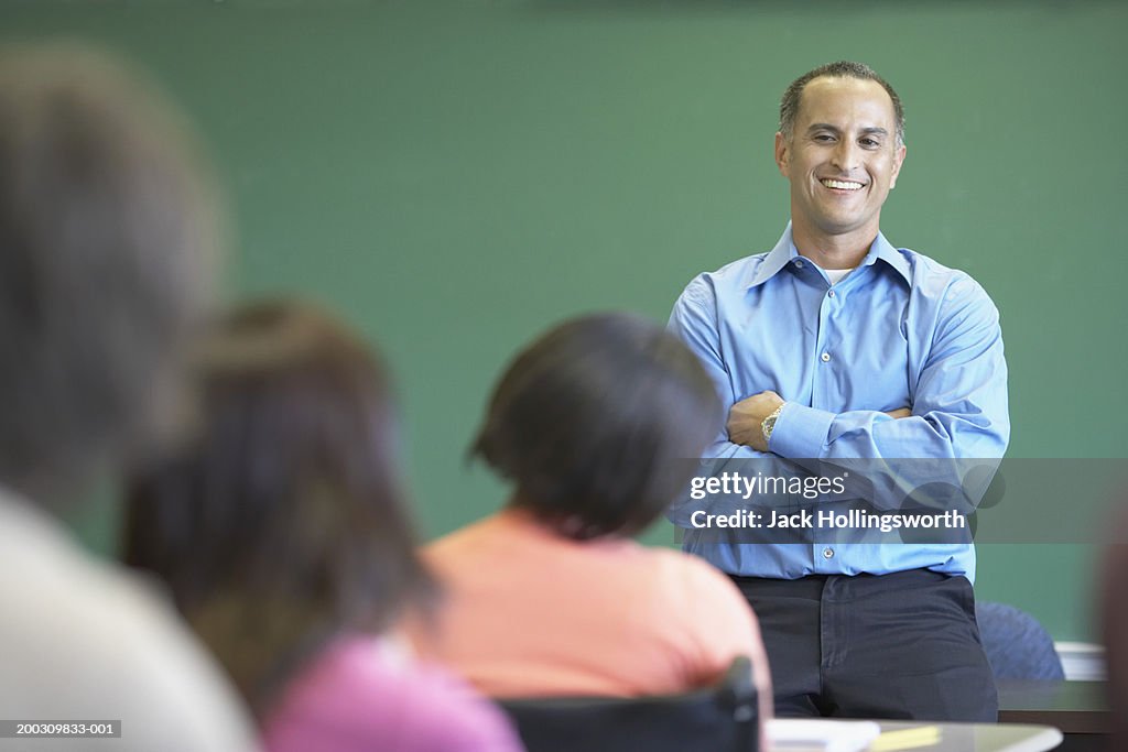 Male lecturer standing in front of a classroom