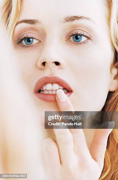 reflection on young woman looking in mirror, close-up - white teeth stock pictures, royalty-free photos & images