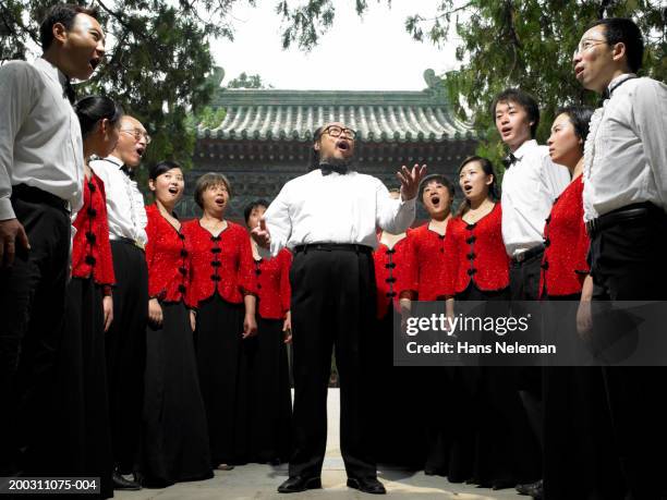 members of choral group practicing in park - choir ストックフォトと画像