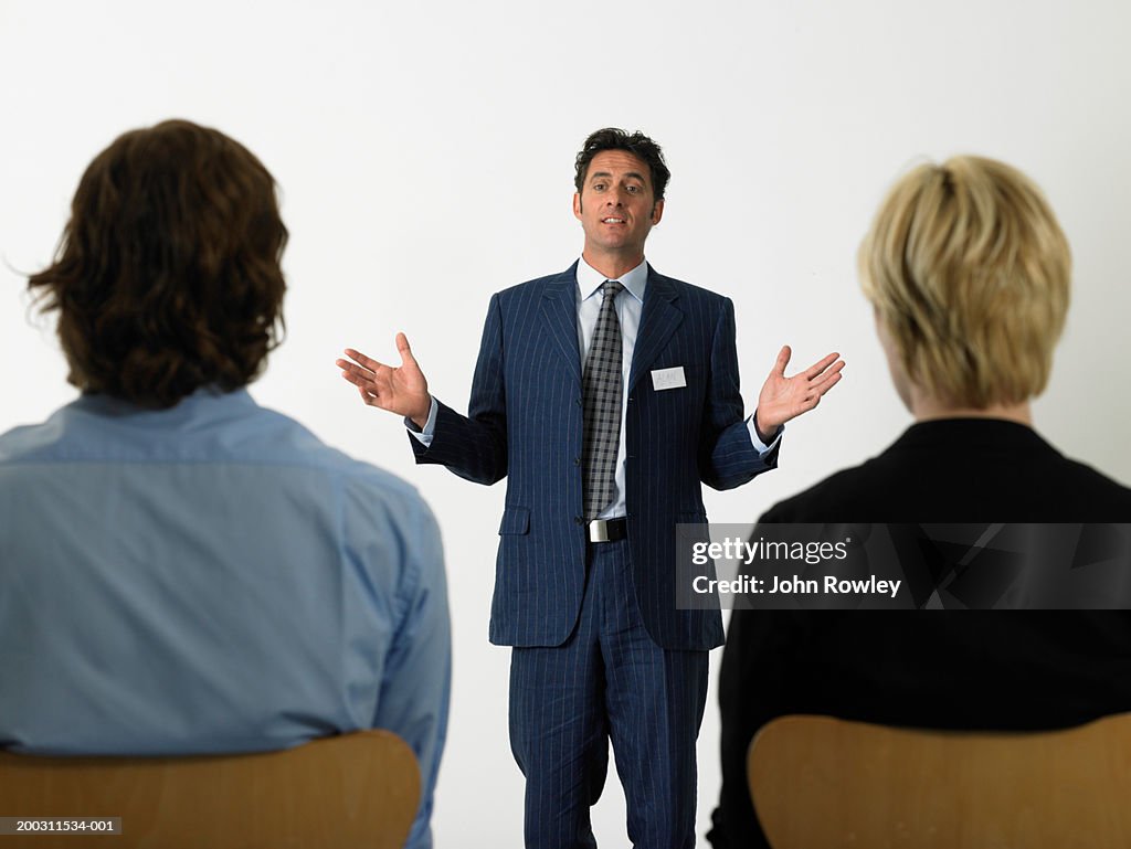 Businessman giving presentation holding out hands