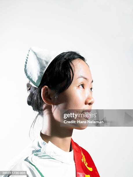 young woman wearing winner's sash over traditional costume, side view - sash fotografías e imágenes de stock