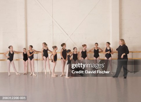 Girls (9-13) in ballet class with ballet instructor Girls (9-13) in ballet class with ballet instructor
