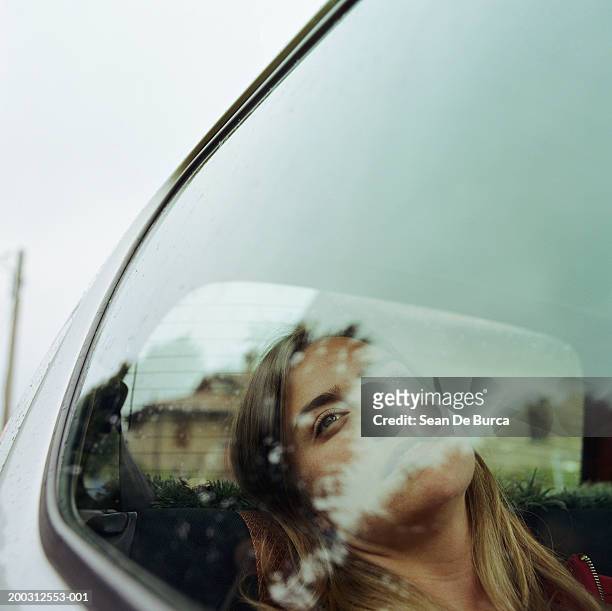 woman looking out of car window, reflection of trees on face, close-up - looking out car window stock pictures, royalty-free photos & images