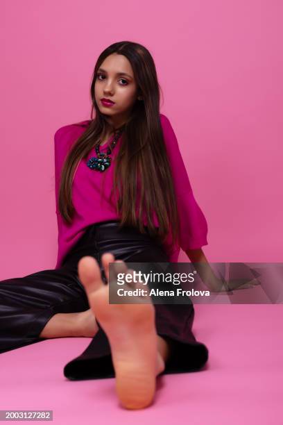 beautiful girl standing and smiling and dressing magenta jumper, leather trousers  pink background springtime - teen boots russian stock pictures, royalty-free photos & images