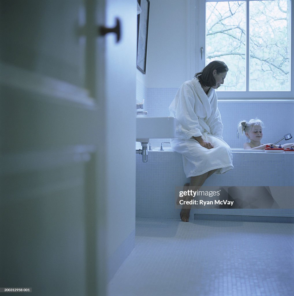 Mother and daughter (2-3) in bathroom