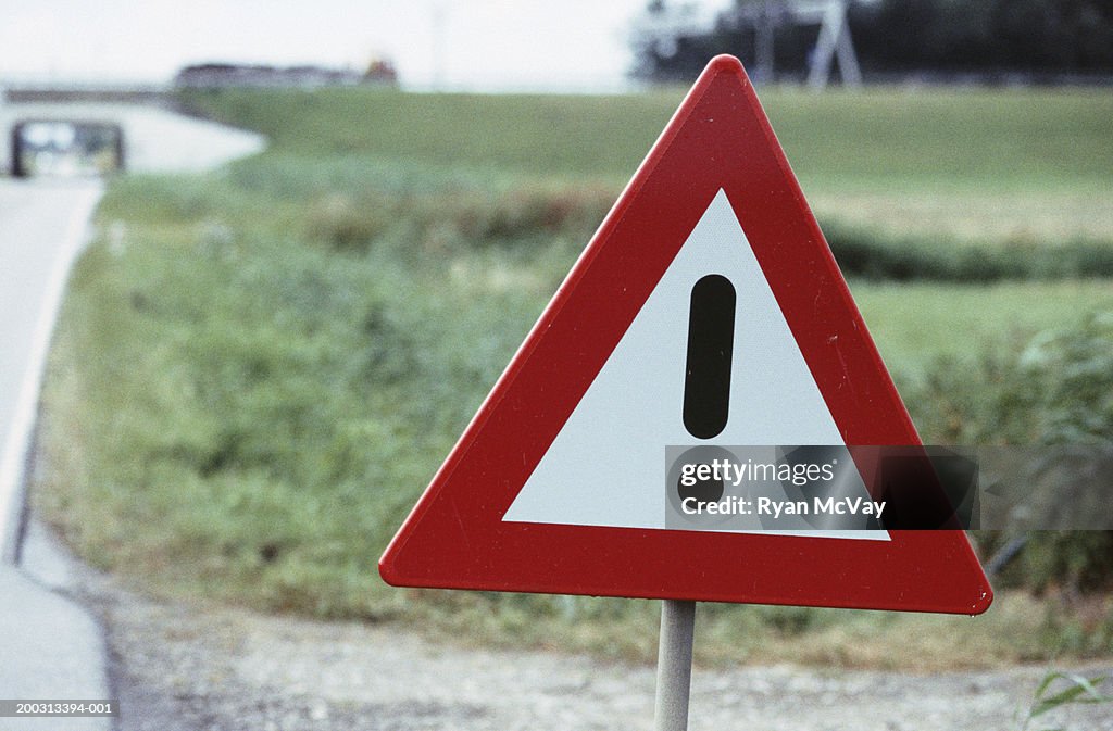 Hazard warning sign by country roadside, close-up