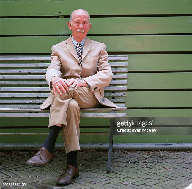 man with moustache sitting on bench, outdoors, portrait - cream colored suit stock pictures, royalty-free photos & images