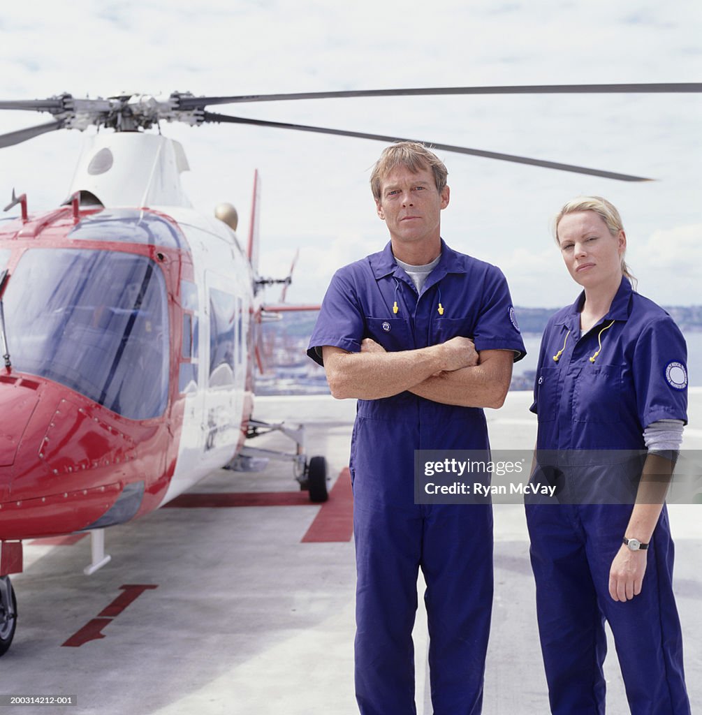 Emergency rescue workers standing in front of helicopter, portrait