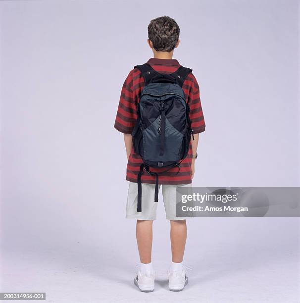 teenage boy (14-15) with rucksack, posing in studio - teen boy shorts stock pictures, royalty-free photos & images