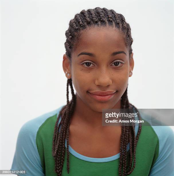 teenage girl (16-17) with corn row hairstyle posing in studio, portrait - cornrows stock pictures, royalty-free photos & images