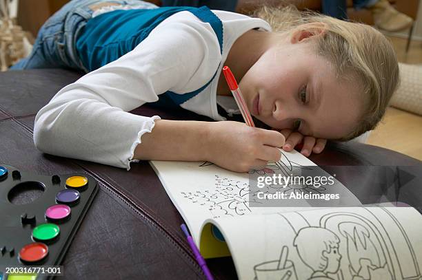 girl (5-7) colouring in book, close up - malbuch stock-fotos und bilder