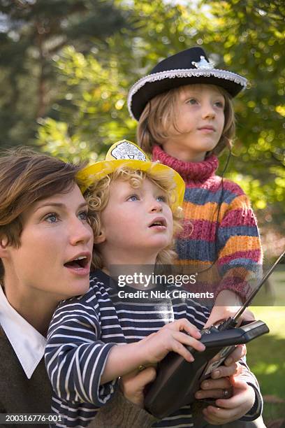 mother and children (2-5) using remote control, outdoors, close-up - radio controlled handset stock pictures, royalty-free photos & images