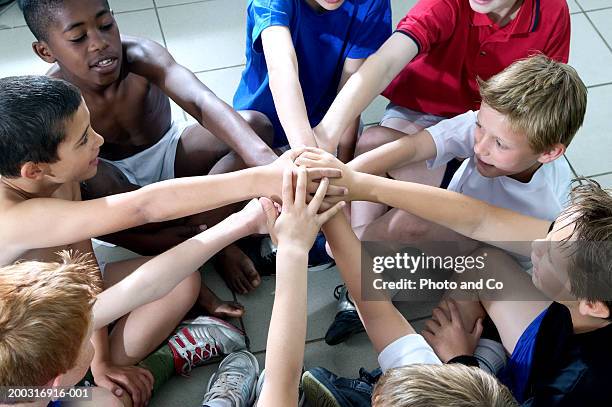 group of boys (9-12) sitting in circle with hands together in centre - high school locker room stock pictures, royalty-free photos & images