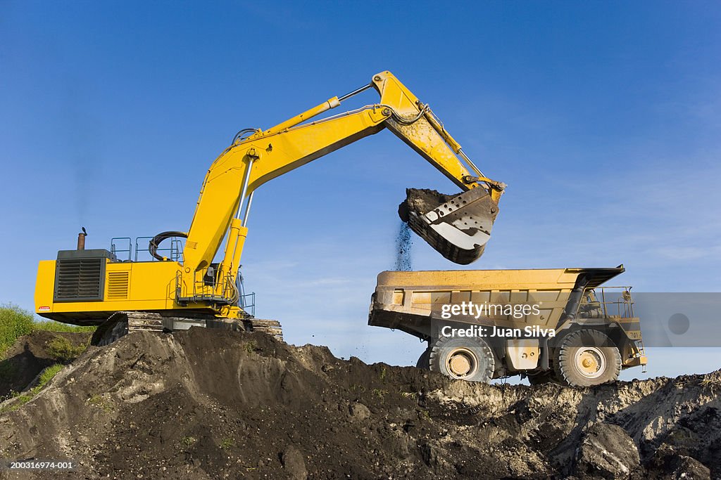 Evcavator and dump truck