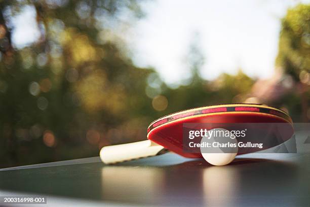 table tennis paddle and ball on table outdoors, close-up - table tennis stock pictures, royalty-free photos & images