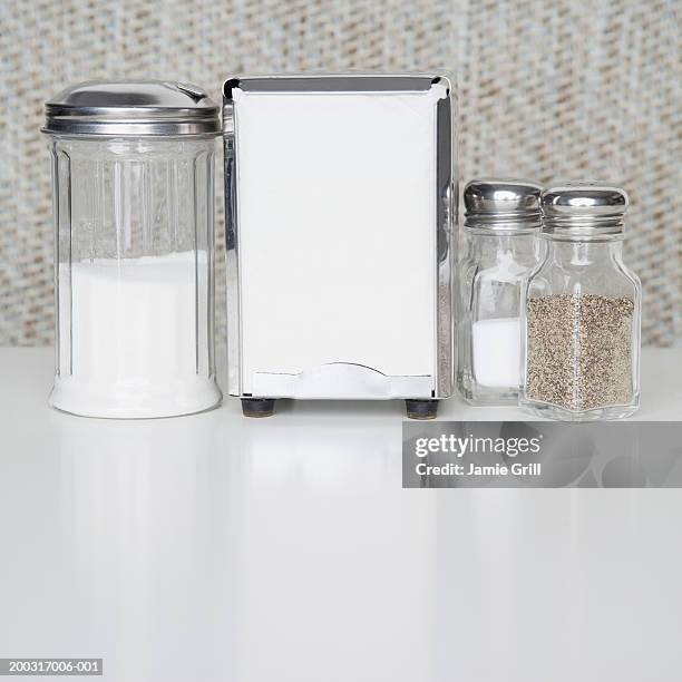 diner style set up of napkins, sugar, salt and pepper - serviettenring stock-fotos und bilder