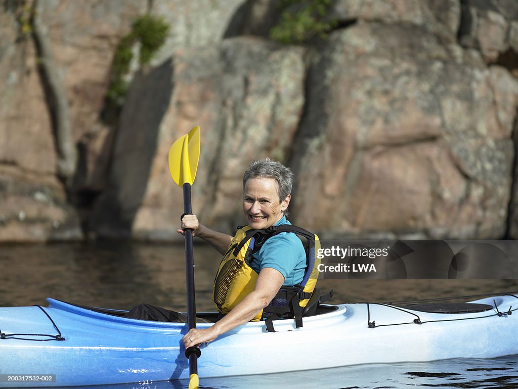 Mature woman in kayak smiling, portrait