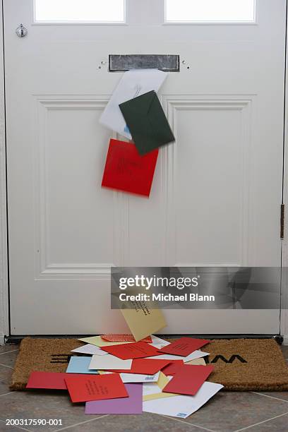 mail falling from letterbox onto doormat (digitally enhanced) - doormat stock pictures, royalty-free photos & images