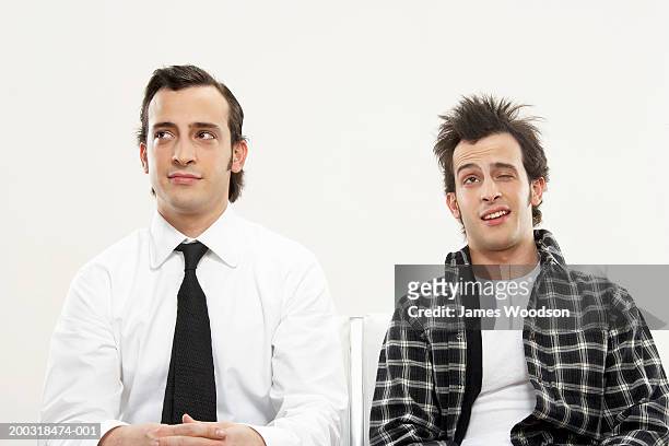 young male twins in formal and casual attire, one winking, close-up - side by side comparison stock pictures, royalty-free photos & images