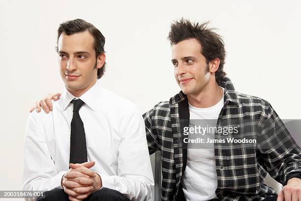 young man with arm around twin brother, close-up - twin stock pictures, royalty-free photos & images