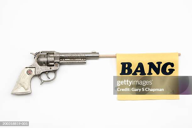 toy gun with flag coming out of barrel reading "bang" - arma de brinquedo imagens e fotografias de stock