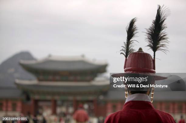 south korea, seoul, kyongbokkung palace, soldier standing guard - feather hat stock pictures, royalty-free photos & images