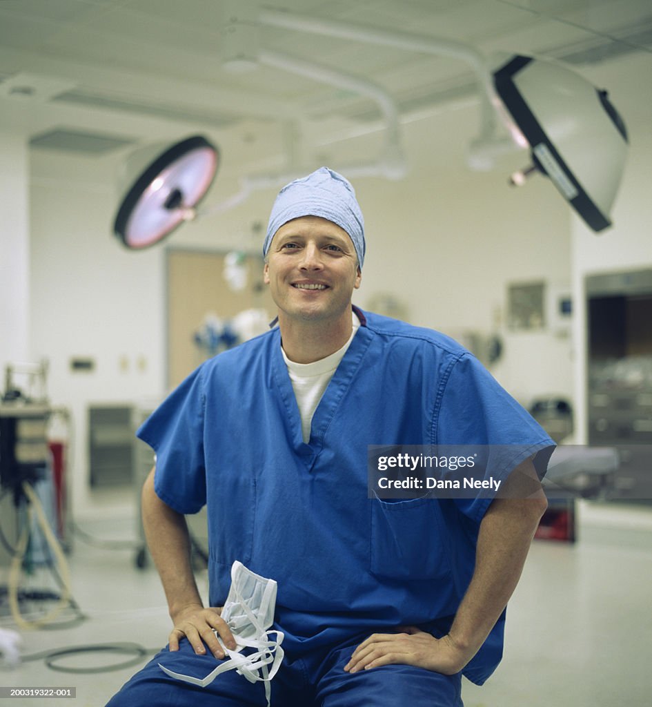 Male surgeon wearing surgical scrubs in operating room, portrait